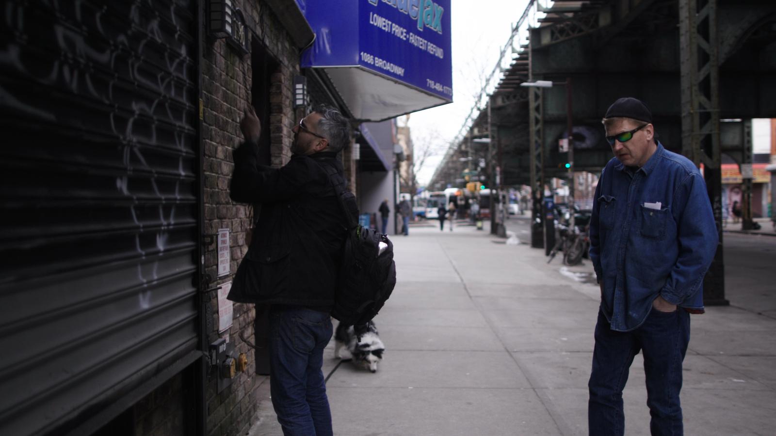 Glick and the tattoo artist outside the tattoo studio.
