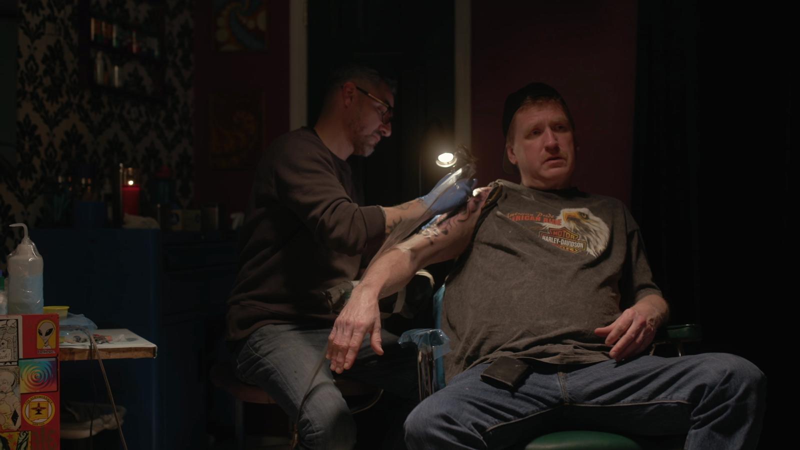 Andrew Glick, former Pagan's Motorcycle Club president turned informant, receives a tattoo.