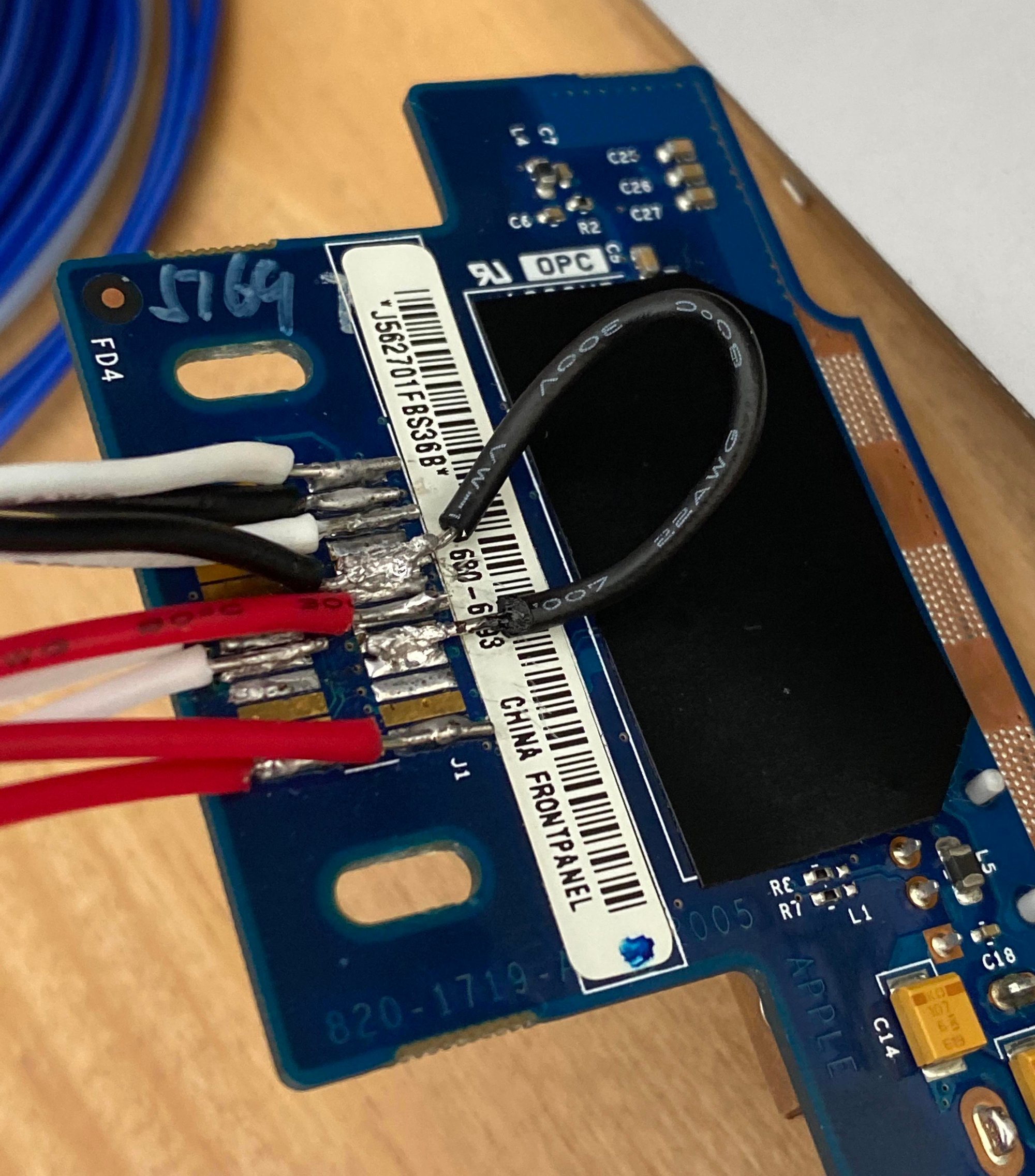 One of the machines we were modifying was a rarer Late 2005 model. For reasons unknown, this specific model had a different type of front panel switch. Russell soldered it.