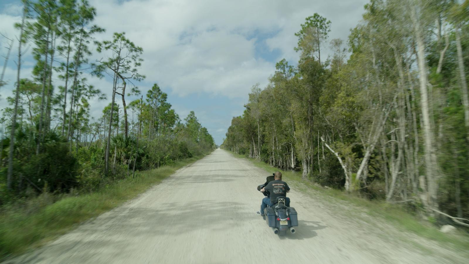 Aerial of Glick riding his motorcycle.